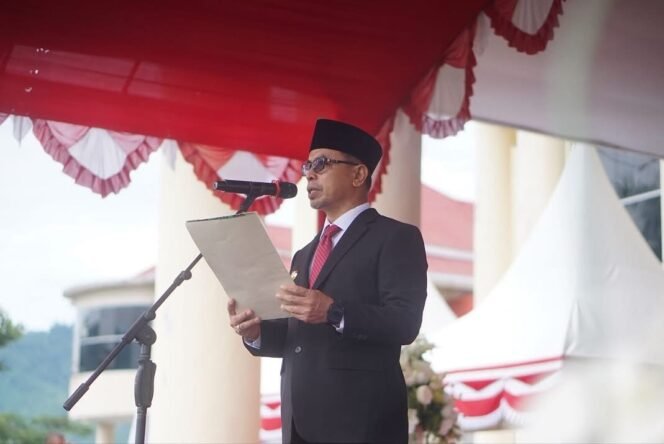 
Bupati Bolmong Utara Sirajudin Lasena membacakan sambutan Mensos